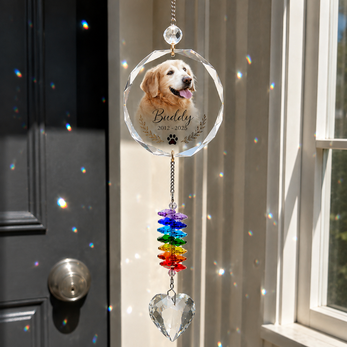 Personalized pet memorial suncatcher with dog photo, name and dates creating rainbow reflections by a sunny window