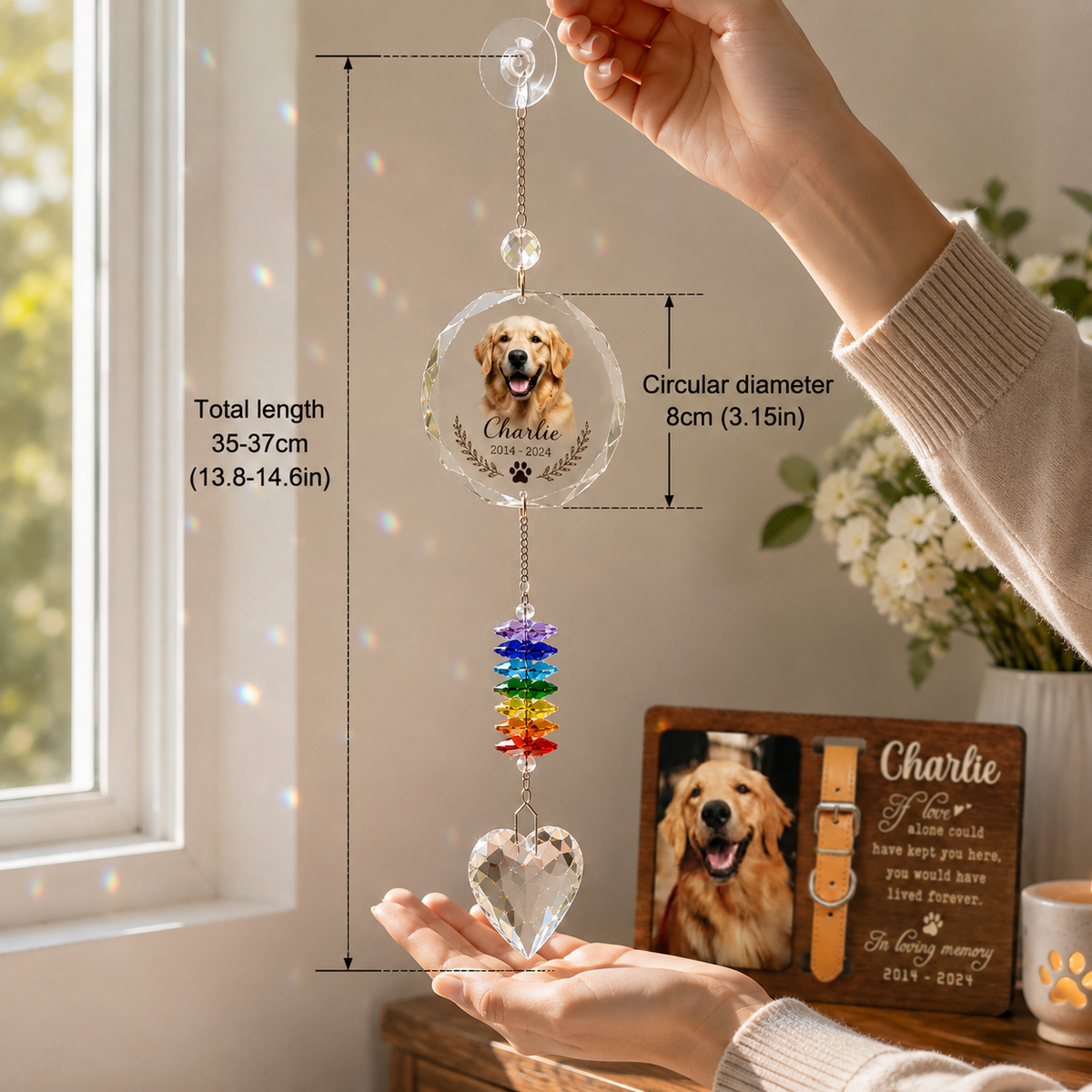 Hand holding a personalized dog memorial suncatcher with crystal prisms near a bright sunny window