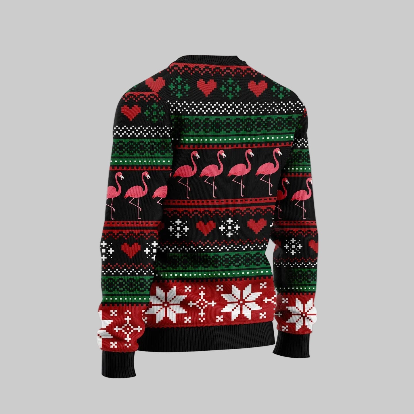 A Christmas sweater with a festive fair isle pattern featuring pink flamingos, red and green hearts, and snowflakes on a black background. The image shows the back view of the sweater against a light gray background with a pinkish glow and white snowflakes, featuring a circular watermark logo for 'Sharkscustom' in the top left corner.